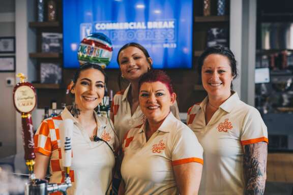 Pine Royale team smiling at grand opening ribbon cutting in Callahan FL